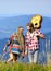 Cheerful couple. western camping. hiking. friendship. campfire songs. men play guitar for girl. happy friends with