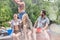 Cheerful couples enjoying on pier at lakeshore during summer