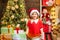 Cheerful cute child opening a Christmas present. Happy child decorating Christmas tree. Cute little child near Christmas