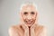 Cheerful cute naked elderly woman posing