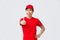 Cheerful delivery guy in uniform encourage make more orders shopping online. Handsome asian courier thumb-up, guarantee