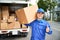 Cheerful delivery man with box