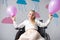 cheerful disabled girl holding balloons and smiling at camera