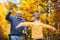 Cheerful disabled grandfather in walker welcoming his happy grandson