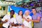 Cheerful diverse soccer supporters holding the flag of Ukraine and enjoing beer, spending time together in the sport bar