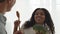 Cheerful Diverse Spouses Singing Holding Broccoli Cooking In Modern Kitchen