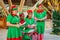 Cheerful diversity male and female christmas elves singing song during celebration party