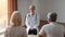 Cheerful Doctor Lady Consulting Senior Couple During Appointment Indoor