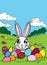 Cheerful Easter bunny with colorful Easter eggs in the fields