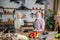 Cheerful elderly couple baking tasty cookies together