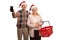 Cheerful elderly couple with christmas santa hats and an empty shopping basket i