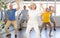Cheerful elderly woman learning dynamic dances at group choreography lesson