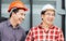 Cheerful engineer man and foreman team at construction site, Happiness factory worker in hard hat at cargo container
