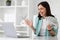 Cheerful excited shocked young caucasian businesswoman in suit at table with computer hold lot of money dollars