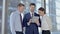 Cheerful Executive Business people Using Tablet and Smiling in Boardroom