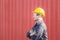 Cheerful factory worker man in hard hat smiling with arms crossed as sign of Success