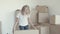 Cheerful fair haired little girl posing in new apartment