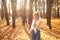 Cheerful, fairy, stylish smiling blond woman in eyeglasses walk in golden forest, straighten hair and joying warm autumn