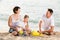 Cheerful family with children playing at beach