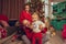 Cheerful family with daughter celebrate Christmas and New year together