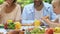 Cheerful family eating fresh homemade pizza, picnic outdoors, home traditions