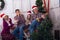 Cheerful family expressive singing in front of a Christmas tree