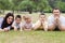 Cheerful family of five lying on lawn