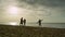 Cheerful family going beach sunset sky ocean. People group walk on sea coast.