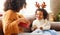 Cheerful family: happy child and mother congratulate each other at Christmas and opening gift