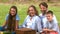 Cheerful family having a picnic in a park