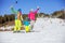 Cheerful family of three standing on ski slope