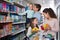 Cheerful family with two daughters purchasing yoghurts