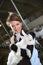 Cheerful farmer in barn with goats