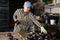 Cheerful farmer grading and packing eggplants in farm warehouse