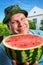 Cheerful farmer with watermelon