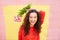 Cheerful fashionable curly woman holding bunch of flowers