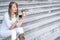 Cheerful fashionable woman holding coffee outdoors