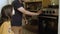 Cheerful father and daughter looking at baking oven in kitchen.