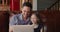 Cheerful father and little daughter having fun using laptop