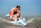 Cheerful father and son swimming in the sea on inflatable toy do