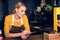 Cheerful female barista noting document in cafe