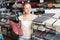 Cheerful female buying tablecloths in home store