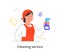 Cheerful female cleaning company member is cleaning premise with spray on white background