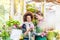 Cheerful female customer buying flowers at the advice of a helpful vendor