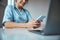 Cheerful female doctor using mobile phone in clinic