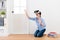 Cheerful female student kneeling on wooden floor