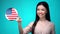 Cheerful female student pushing USA flag button, ready to learn foreign language