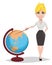 Cheerful female teacher standing near globe and showing on it with a pointer.