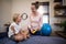 Cheerful female therapist and boy looking at each other with electrical muscle stimulation machine