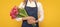 cheerful flower seller woman in apron with spring tulip flowers on yellow background